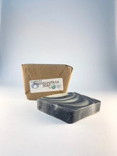 Load image into Gallery viewer, 2 Bars of AF27 Sensitive Skin Soap which are handmade with care, 1 bar shown in our compostable package the other is open laying on it&#39;s side.
