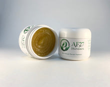 Load image into Gallery viewer, 2 Jars of AF27 Peppermint Salve Extra Strength Psoriasis Treatment for moderate to severe cases of psoriasis and eczema, 1 jar shown on it&#39;s side with the lid off.
