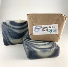 Load image into Gallery viewer, 3 Bars of AF27 Sensitive Skin Soap which are handmade with care, 1 bar shown in our compostable package, the other 2 are opened 1 standing upright the other laying on it’s side.
